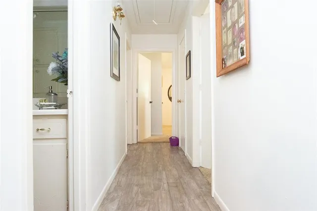 a view of a hallway with wooden floor