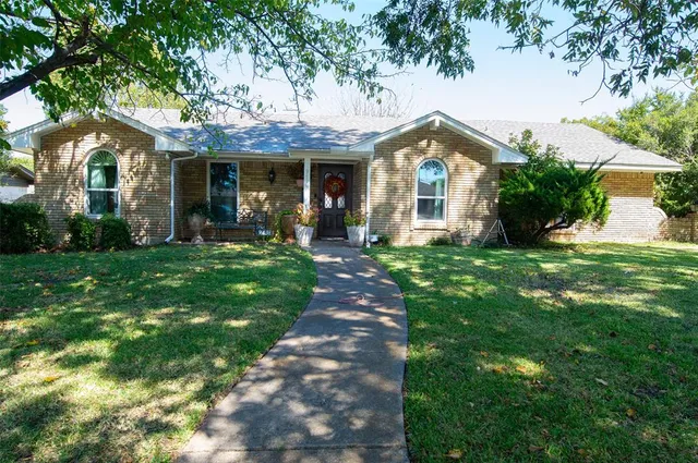 a front view of a house with a yard and porch