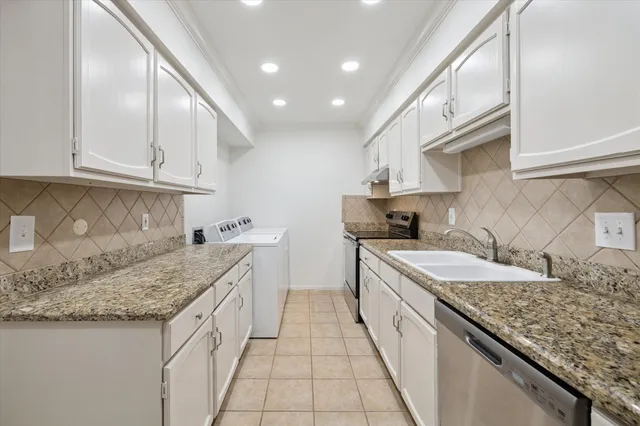 a kitchen with granite countertop kitchen island a sink a counter top space and cabinets