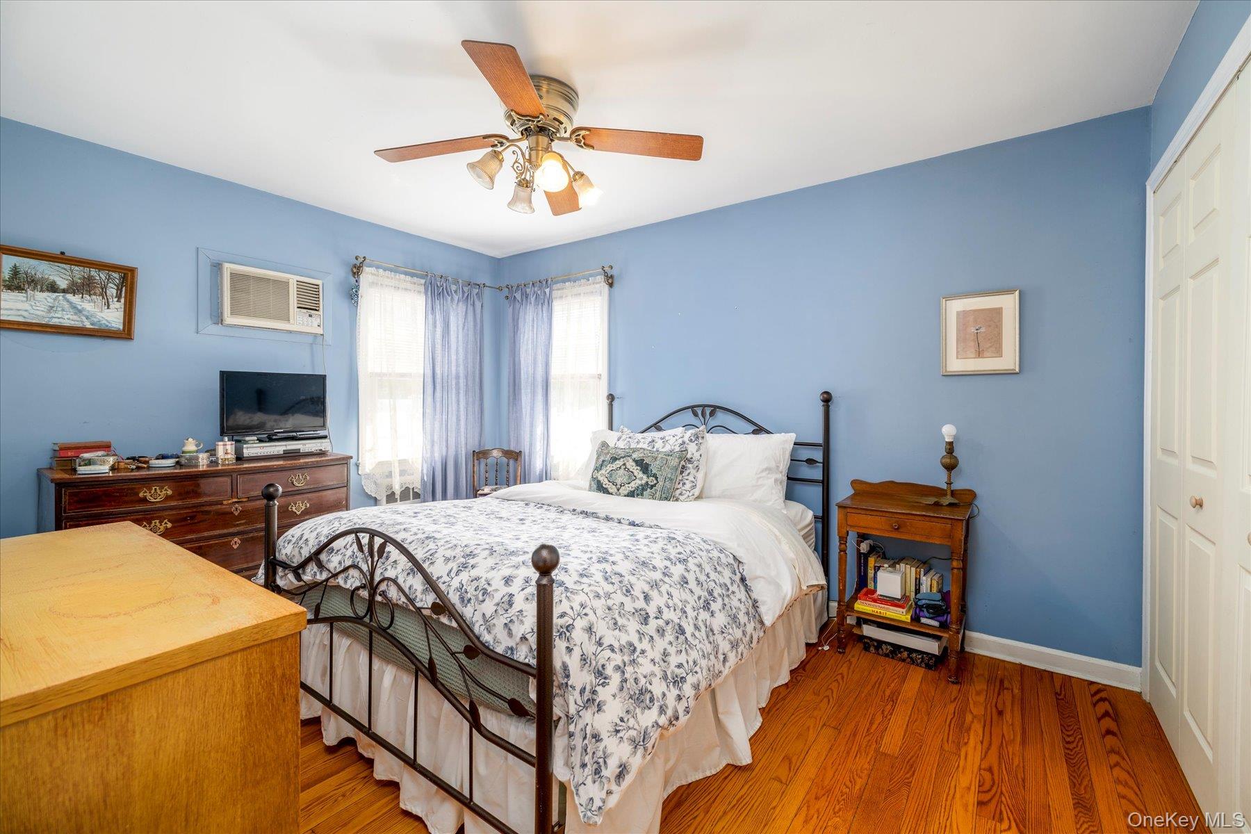 11 Maple Street Malverne, NY 11565 - Photo 11 of 18 a bedroom with a bed and a chandelier