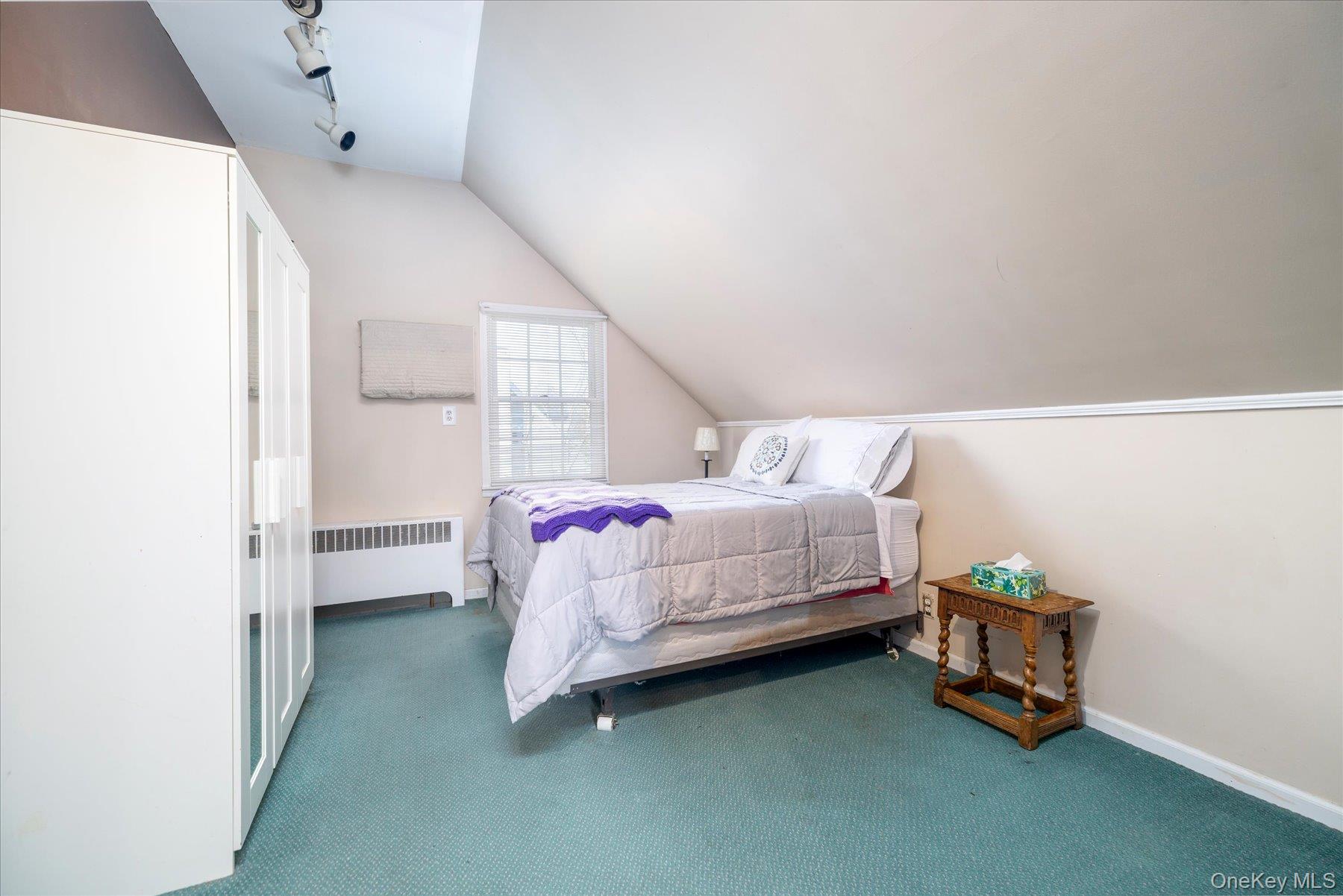 11 Maple Street Malverne, NY 11565 - Photo 13 of 18 a bedroom with a bed and a window