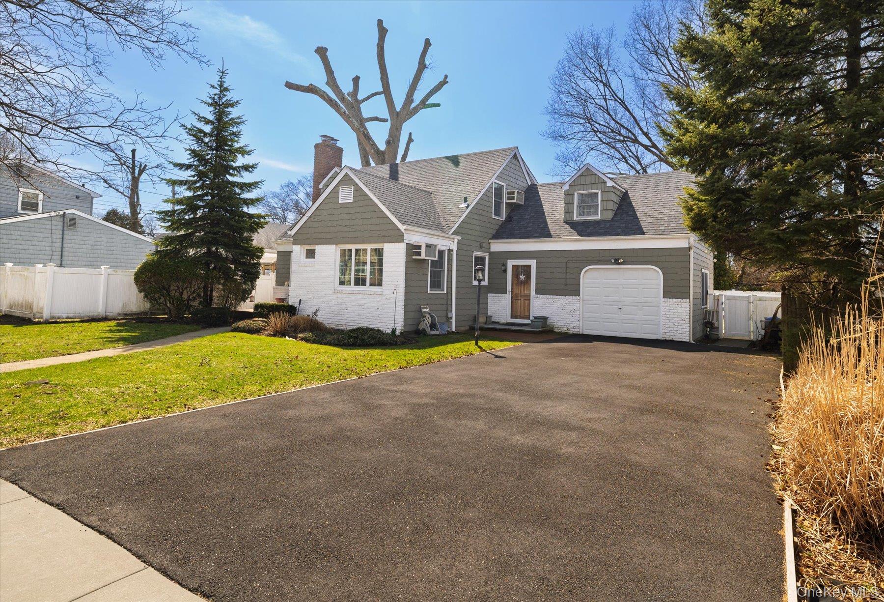 11 Maple Street Malverne, NY 11565 - Photo 2 of 18 a front view of a house with yard and large tree