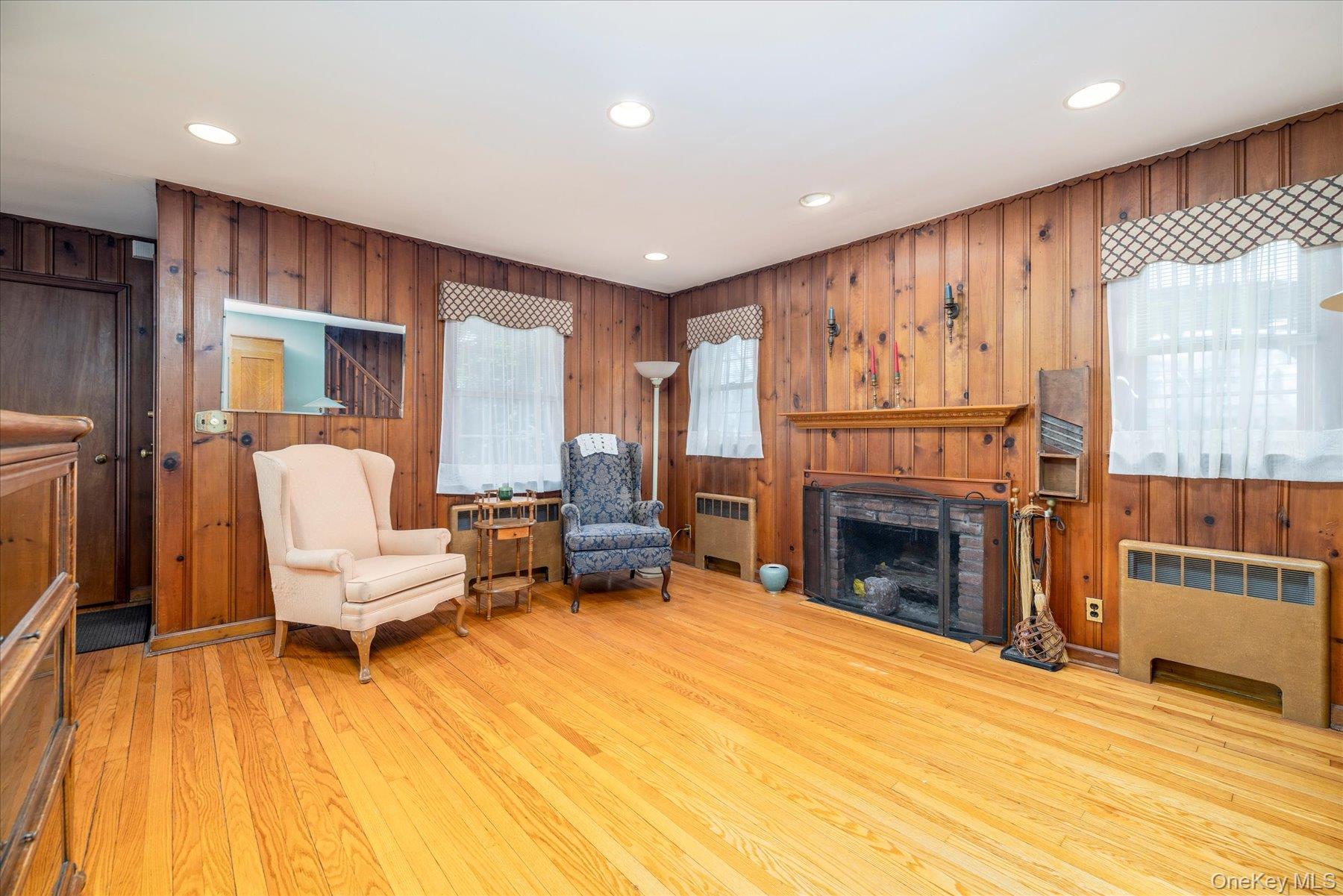 11 Maple Street Malverne, NY 11565 - Photo 3 of 18 a living room with furniture and a fireplace