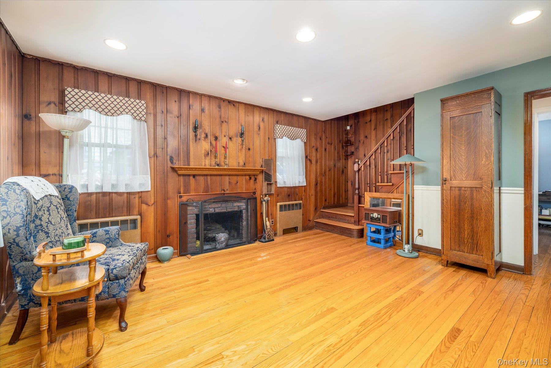 11 Maple Street Malverne, NY 11565 - Photo 4 of 18 a view of a livingroom with furniture and a fireplace