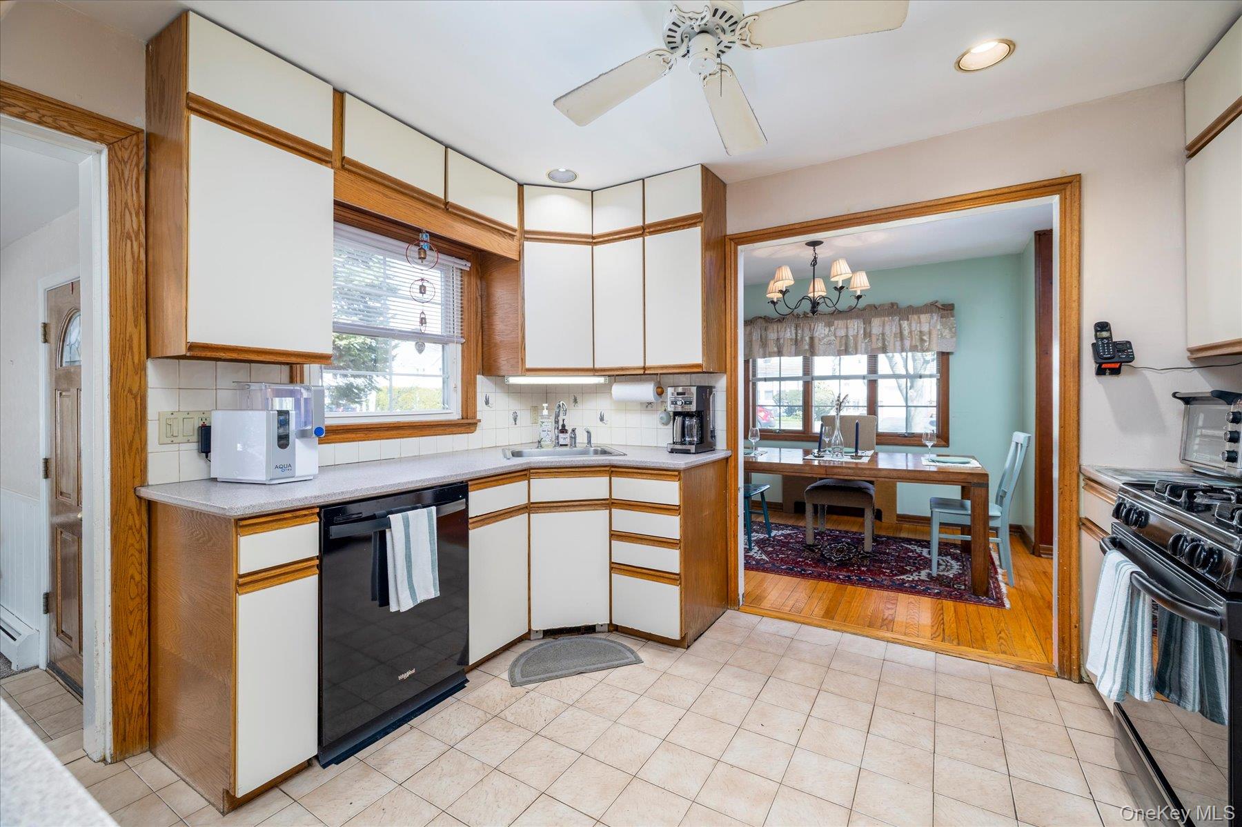 11 Maple Street Malverne, NY 11565 - Photo 6 of 18 a kitchen with stainless steel appliances granite countertop a stove a sink and a refrigerator