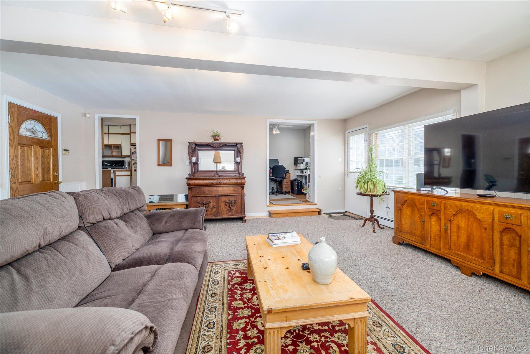 11 Maple Street Malverne, NY 11565 - Photo 8 of 18 a living room with furniture and a flat screen tv