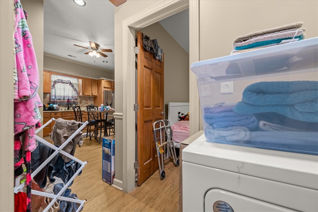 1102 West End Avenue Anderson, SC 29625 - Photo 23 of 28 Functional laundry room leads to a spacious kitchen with rich wood cabinetry and ample counter space.