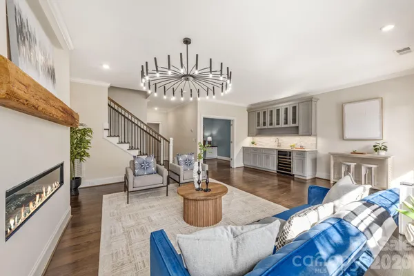 a living room with furniture and a chandelier
