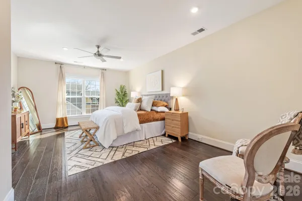 a bed sitting in a bedroom next to a window