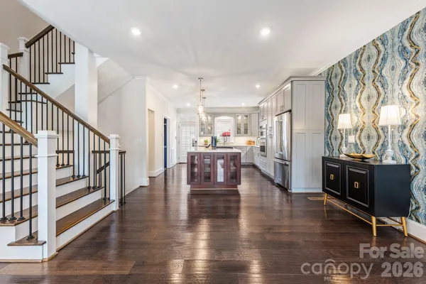 a view of a livingroom with furniture wooden floor and windows