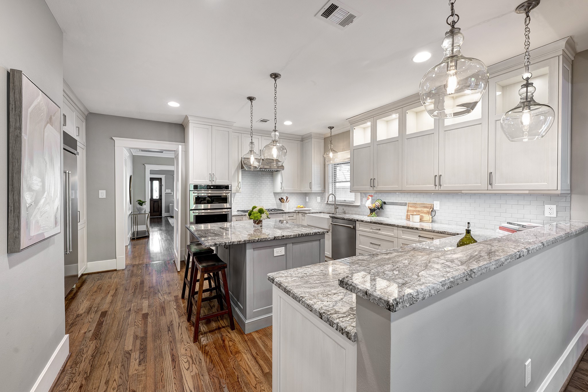 1314 Harvard Street Houston, TX 77008 - Photo 9 of 36 a kitchen with kitchen island granite countertop a sink a counter space stainless steel appliances and cabinets