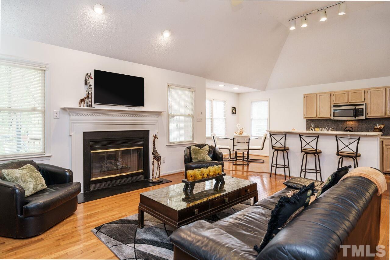 5305 Calverton Drive Raleigh, NC 27613 - Photo 16 of 34 a living room with furniture fireplace and flat screen tv