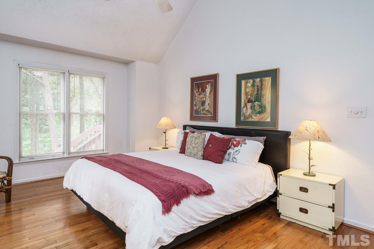 5305 Calverton Drive Raleigh, NC 27613 - Photo 19 of 34 a bedroom with a bed and a night stand