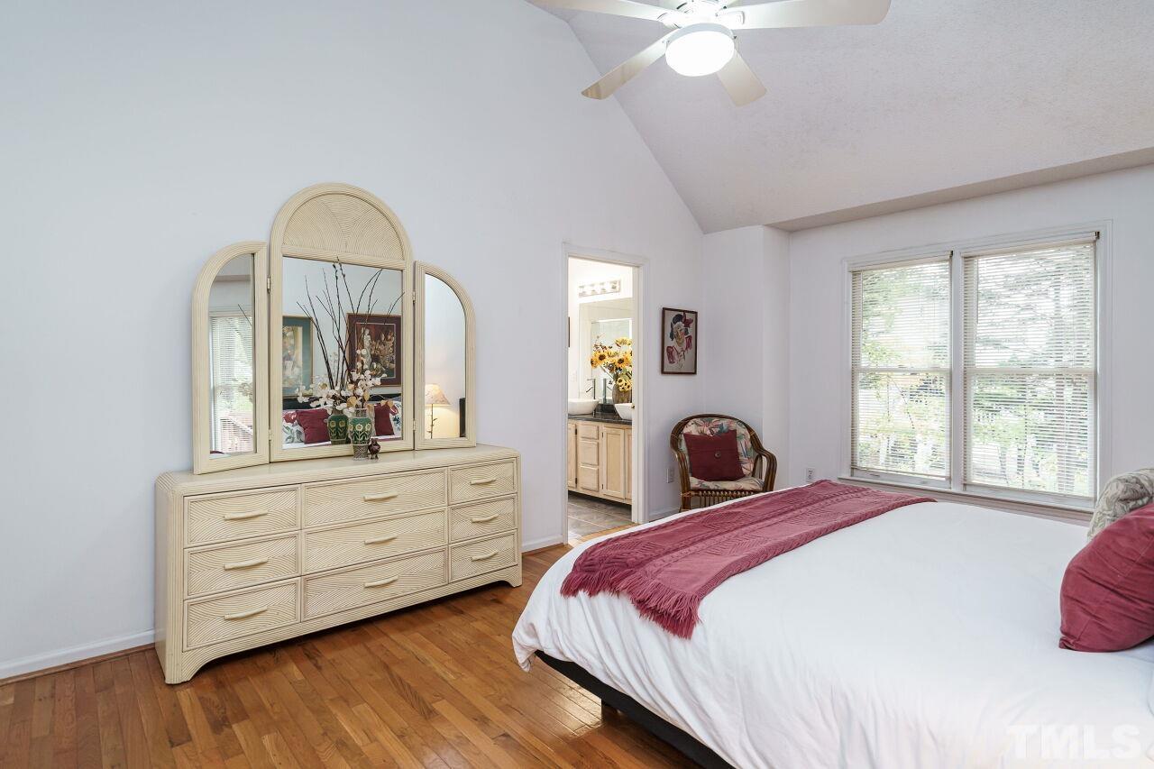 5305 Calverton Drive Raleigh, NC 27613 - Photo 20 of 34 a bedroom with a bed and a dresser