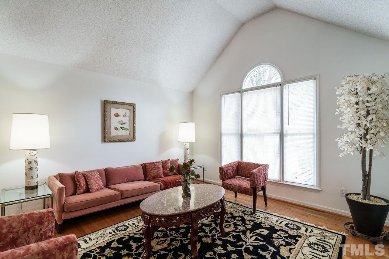 5305 Calverton Drive Raleigh, NC 27613 - Photo 2 of 34 a living room with furniture a window and a potted plant