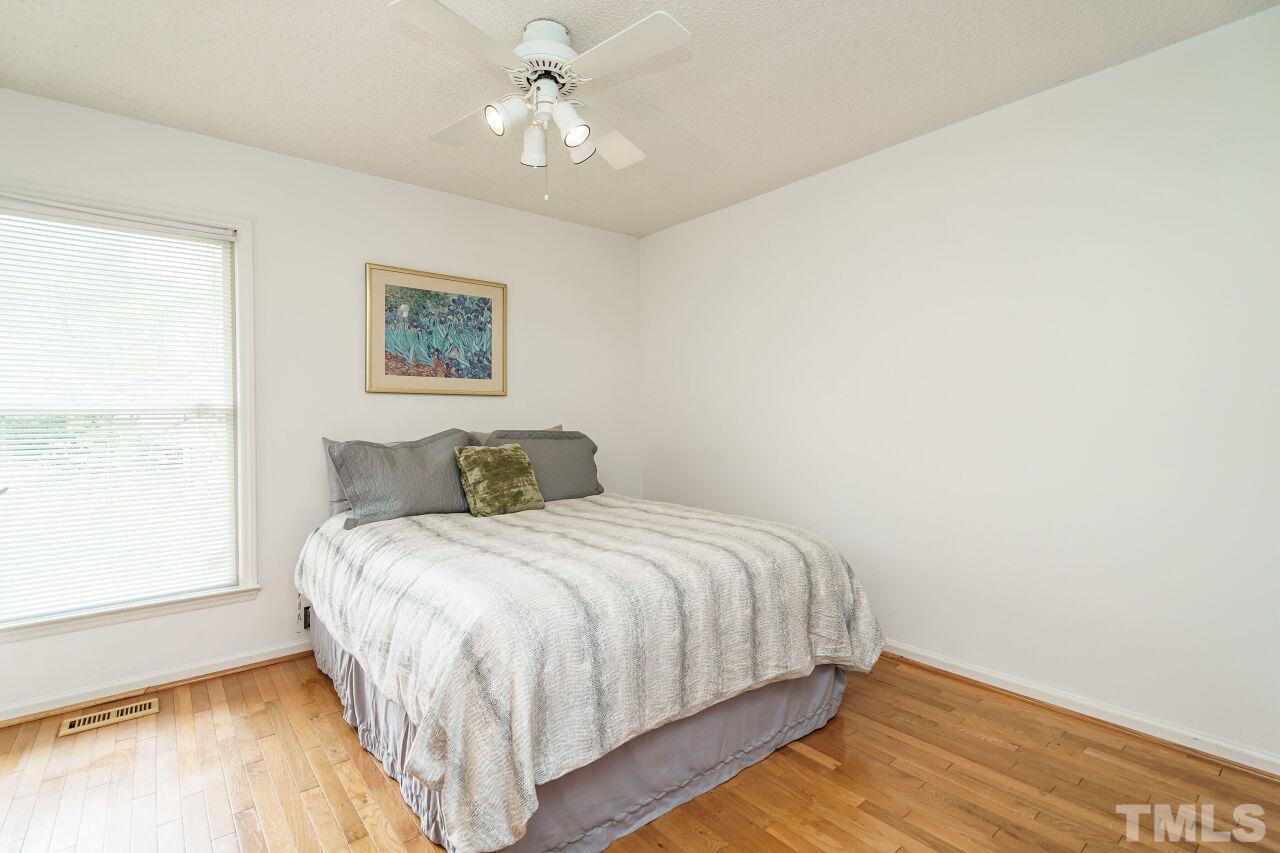 5305 Calverton Drive Raleigh, NC 27613 - Photo 23 of 34 a bedroom with a bed and a window