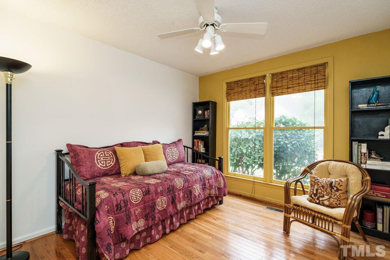 5305 Calverton Drive Raleigh, NC 27613 - Photo 25 of 34 a bedroom with a bed and a large window