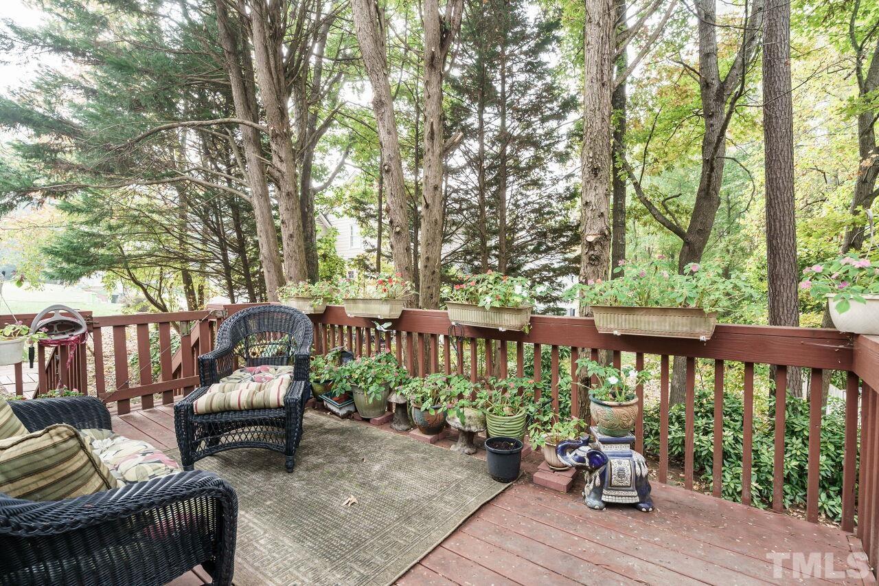 5305 Calverton Drive Raleigh, NC 27613 - Photo 26 of 34 a view of a chair and table on the deck