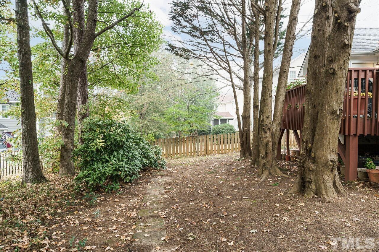 5305 Calverton Drive Raleigh, NC 27613 - Photo 28 of 34 a backyard of a house with lots of green space