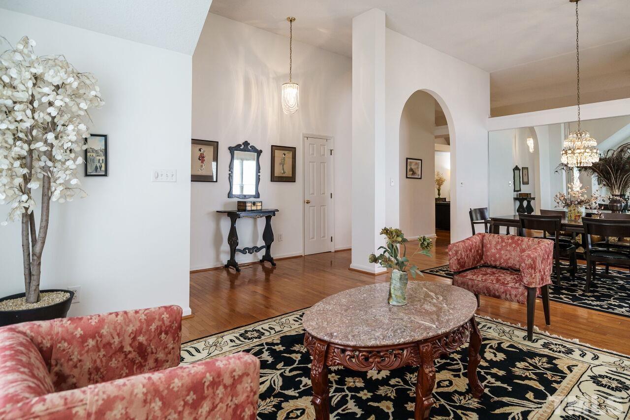 5305 Calverton Drive Raleigh, NC 27613 - Photo 5 of 34 a living room with furniture and a chandelier