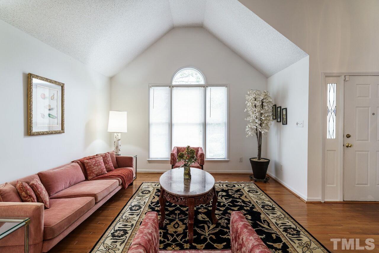 5305 Calverton Drive Raleigh, NC 27613 - Photo 6 of 34 a living room with furniture and a large window