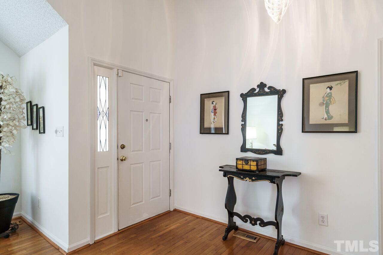 5305 Calverton Drive Raleigh, NC 27613 - Photo 7 of 34 a view of a workspace with furniture and wooden floor