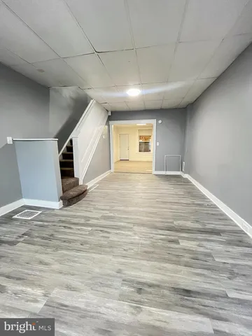 a large kitchen with wooden floors and stainless steel appliances
