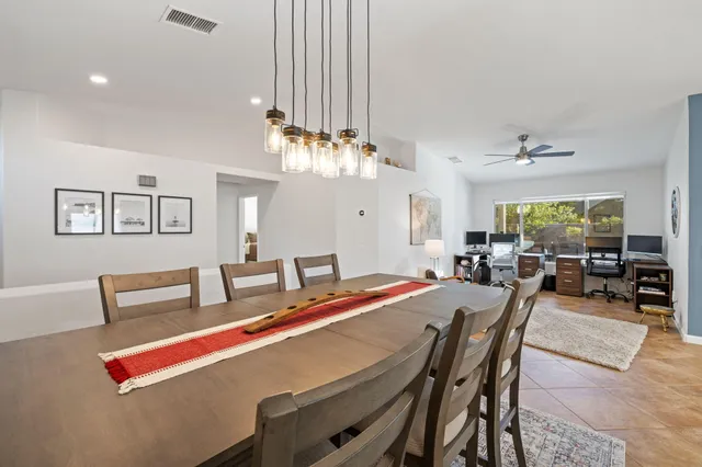 a view of a dining room with furniture and a chandelier
