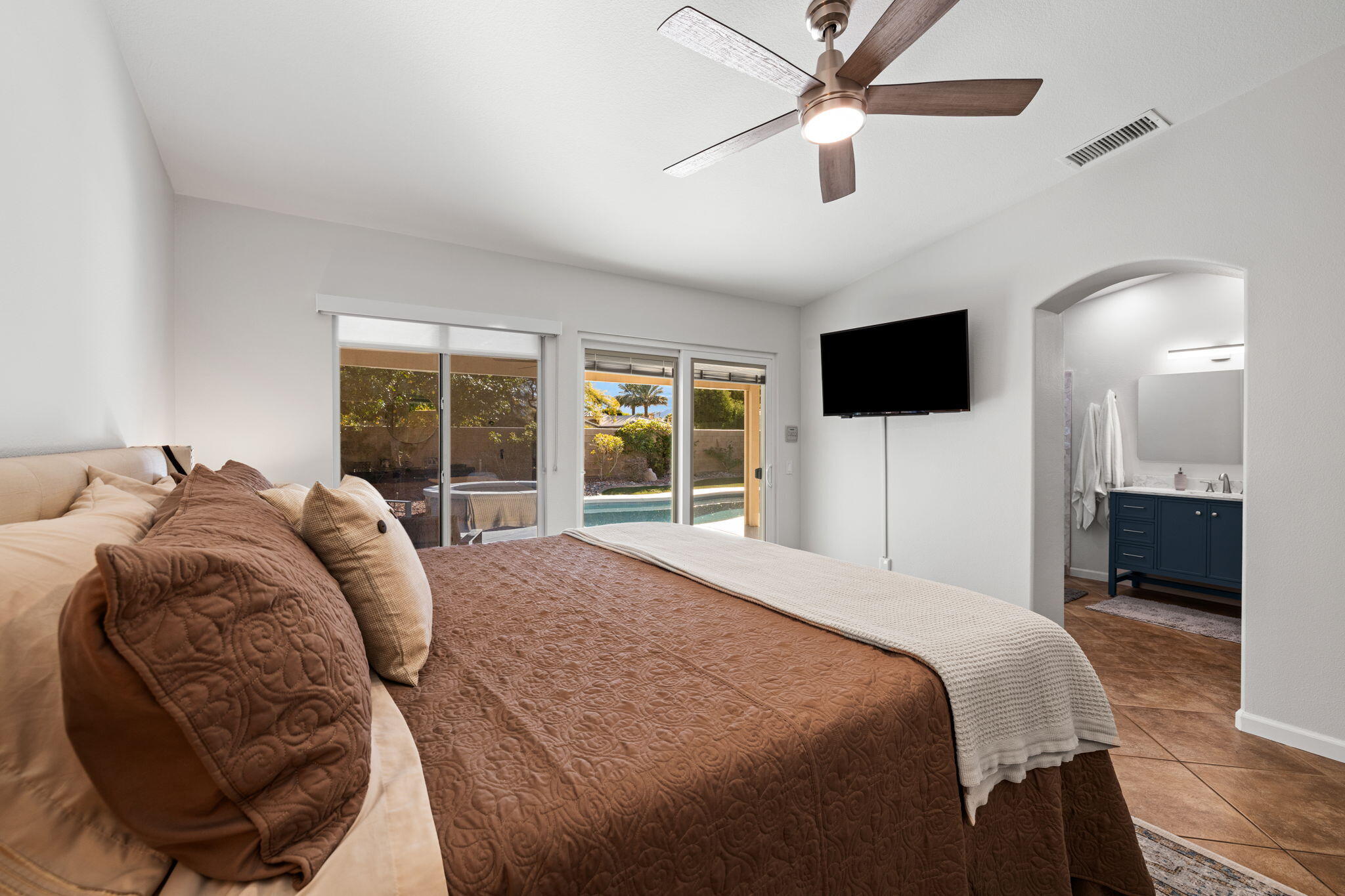 81107 Portola Circle Indio, CA 92201 - Photo 18 of 40 a bedroom with a bed a window and a television