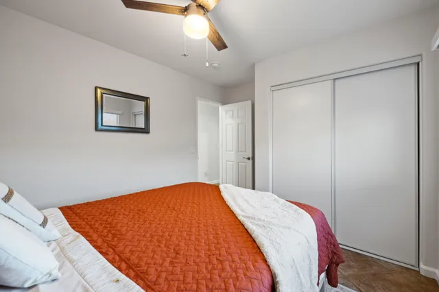 a bed room with a bed and a painting on the wall