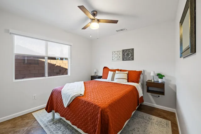 a bedroom with bed and window