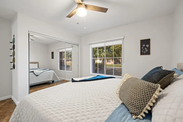 a bedroom with a large bed and a window