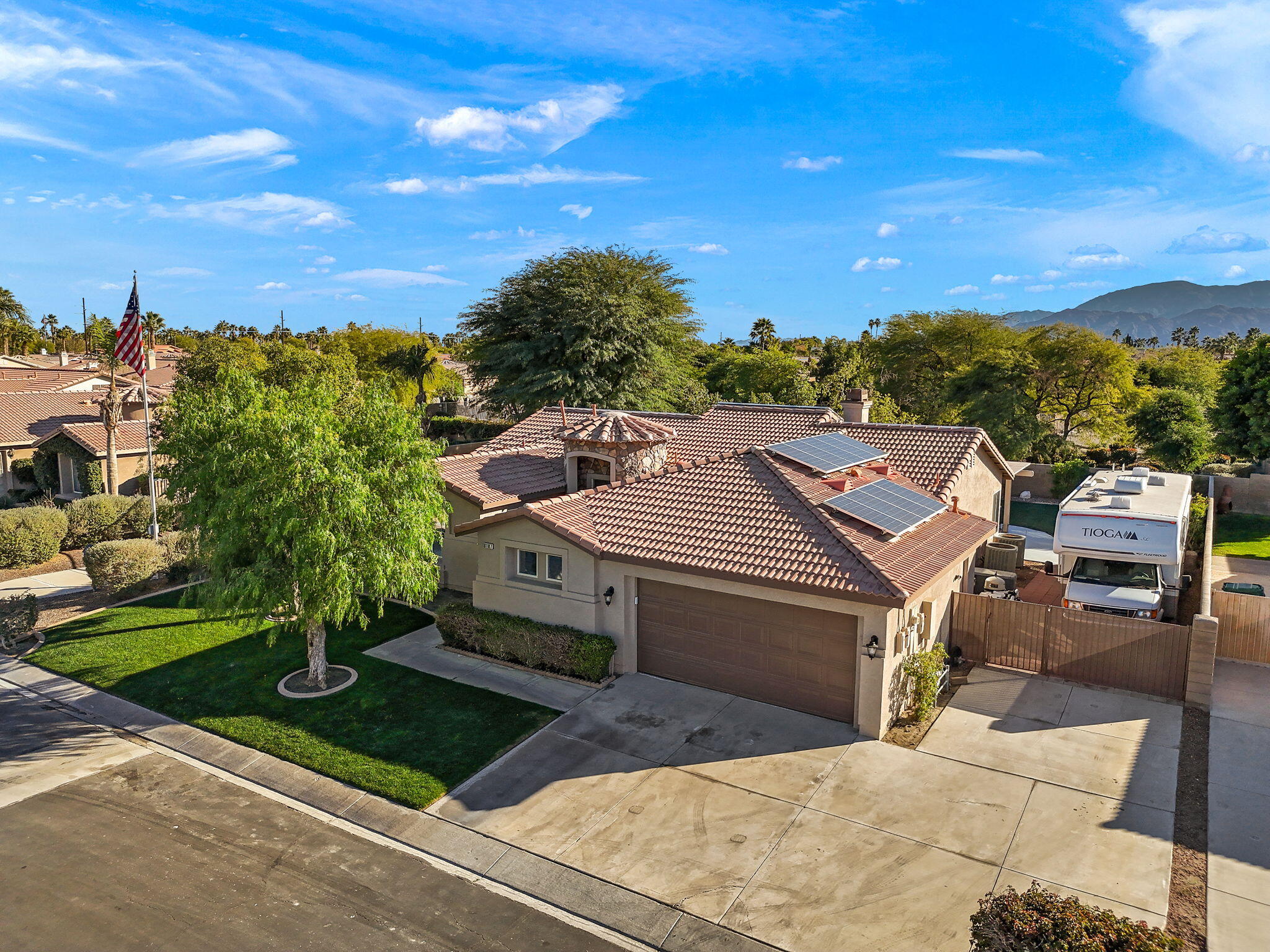 81107 Portola Circle Indio, CA 92201 - Photo 29 of 40 a view of a patio with lawn chairs potted plants and a big yard