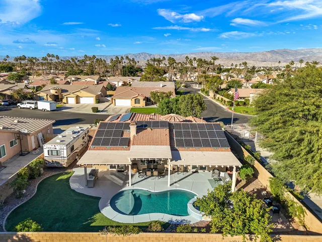 an aerial view of residential houses with outdoor space