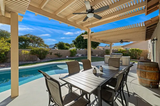 a view of an outdoor dining space with a table and chairs