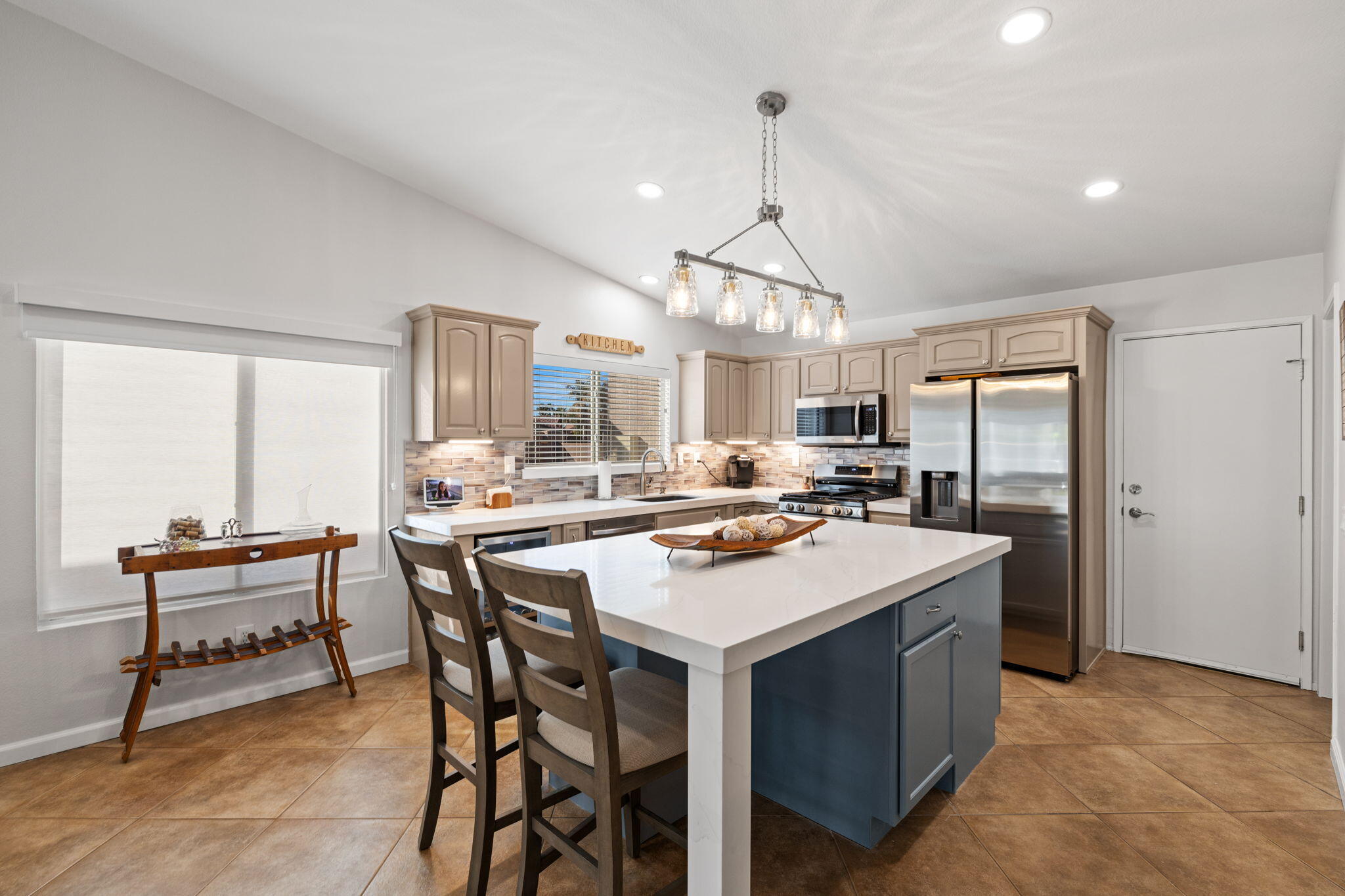 81107 Portola Circle Indio, CA 92201 - Photo 9 of 40 a kitchen with a table chairs refrigerator and cabinets