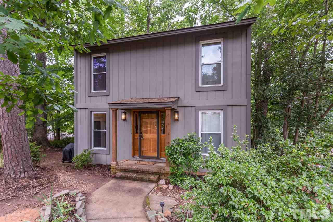 2733 Rue Sans Famille Raleigh, NC 27607 - Photo 1 of 25 a red brick house with trees in front of it