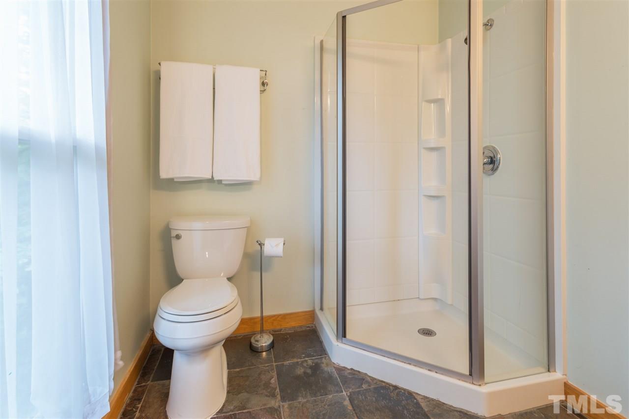 2733 Rue Sans Famille Raleigh, NC 27607 - Photo 13 of 25 a bathroom with a toilet and a shower