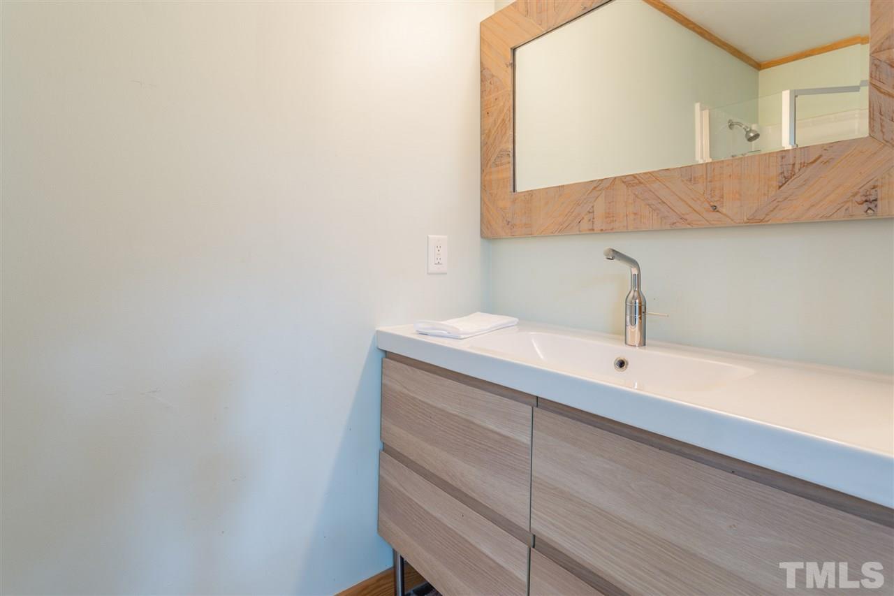 2733 Rue Sans Famille Raleigh, NC 27607 - Photo 14 of 25 a bathroom with a sink and a mirror