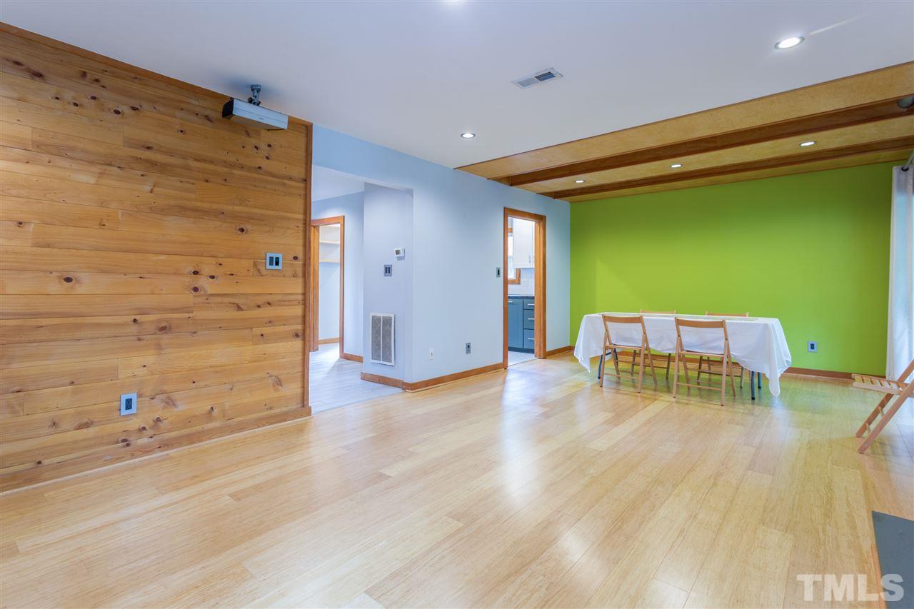 2733 Rue Sans Famille Raleigh, NC 27607 - Photo 4 of 25 a dining room with furniture and a wooden floor