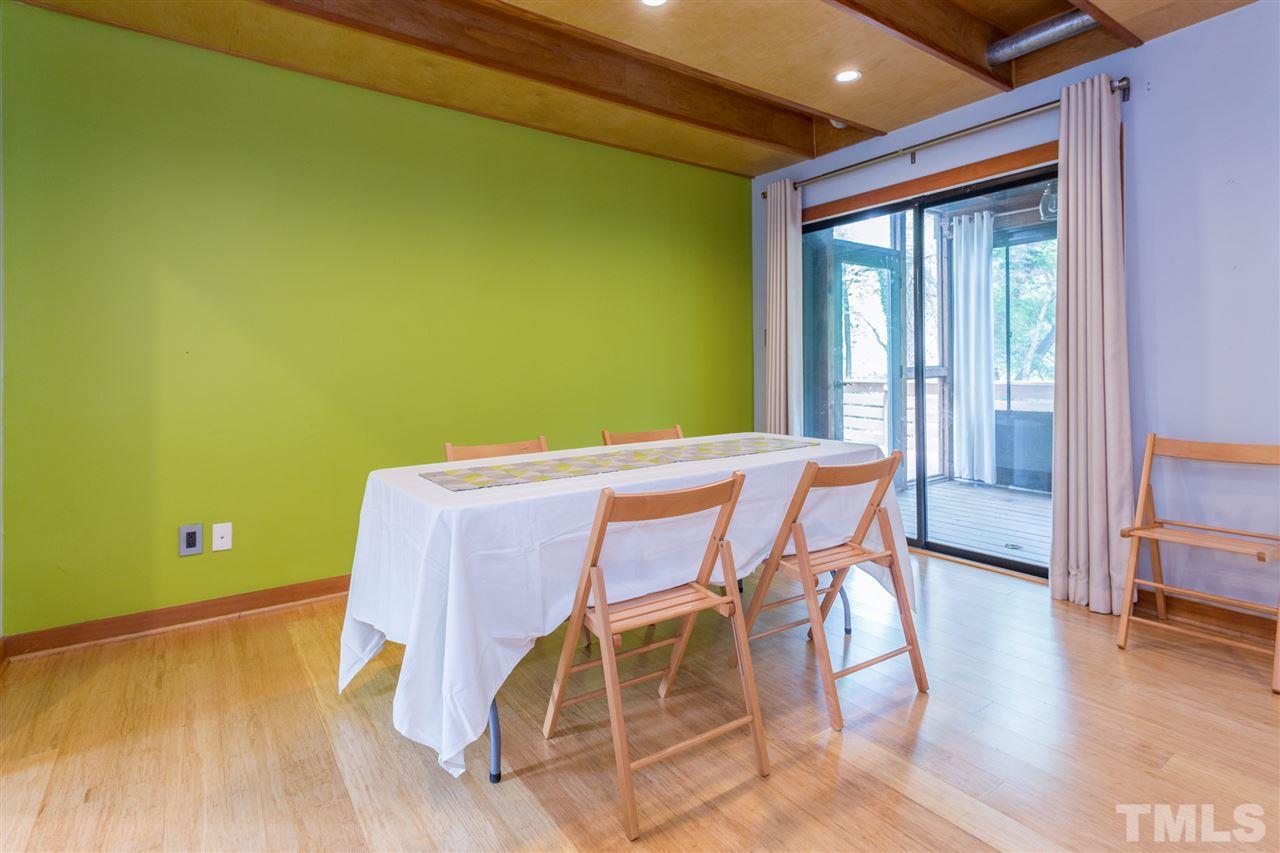2733 Rue Sans Famille Raleigh, NC 27607 - Photo 5 of 25 a view of a dining room with furniture and wooden floor