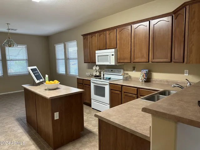 a kitchen that has a sink and a stove in it