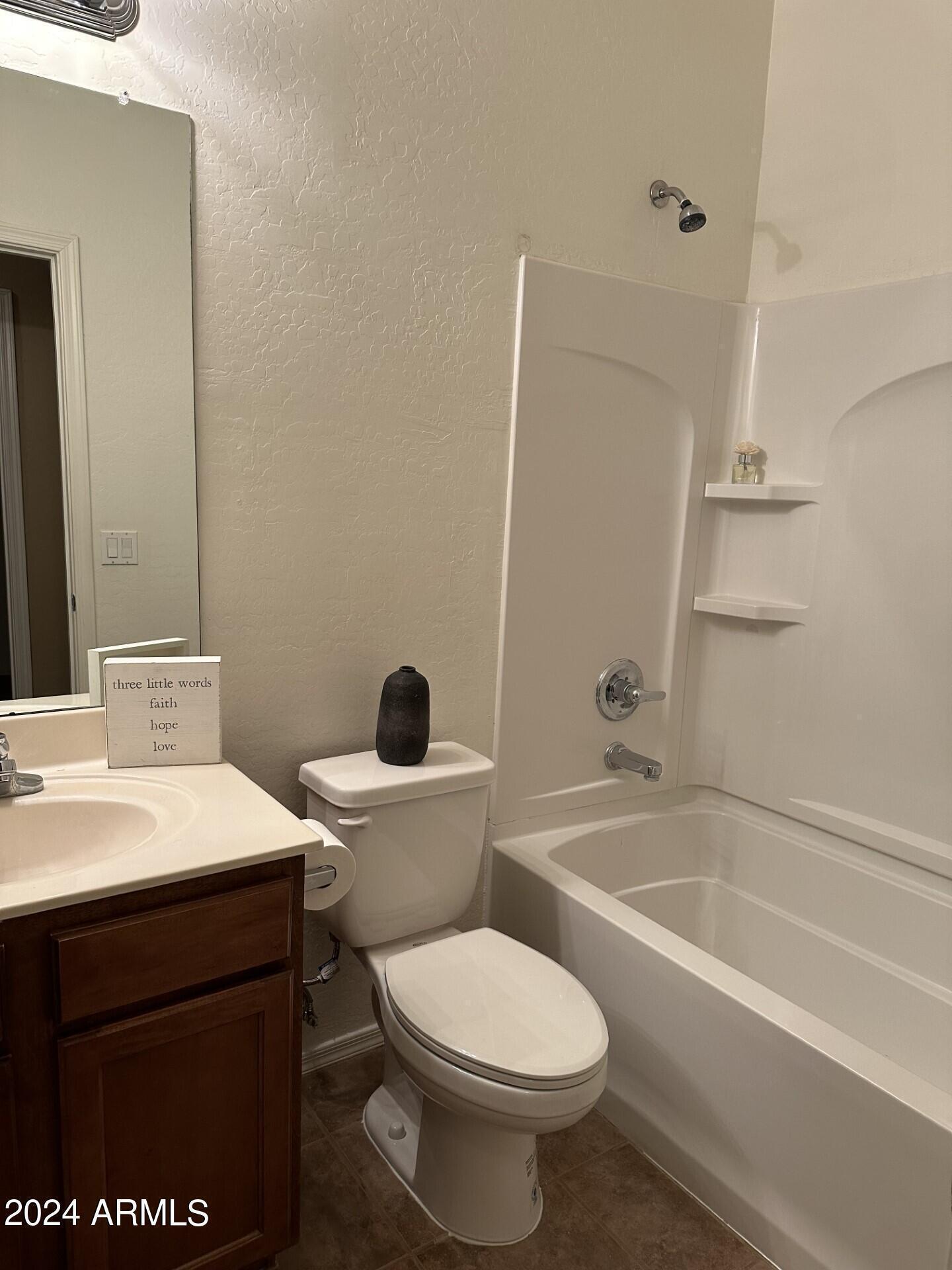 44456 West Eddie Way Maricopa, AZ 85138 - Photo 6 of 18 a bathroom with a sink a toilet and a bathtub