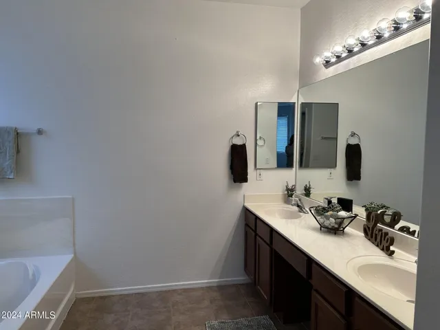 a bathroom with a sink vanity and mirror