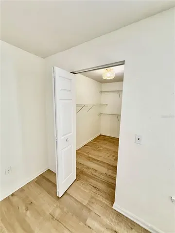 an empty room with wooden floor and white doors