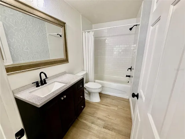 a bathroom with a sink vanity mirror and a toilet