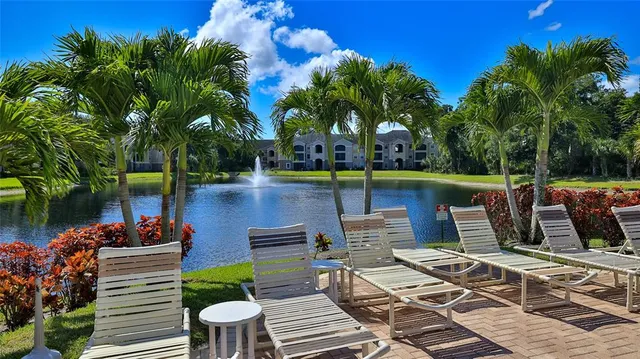a view of a patio with couches table and chairs and potted plants