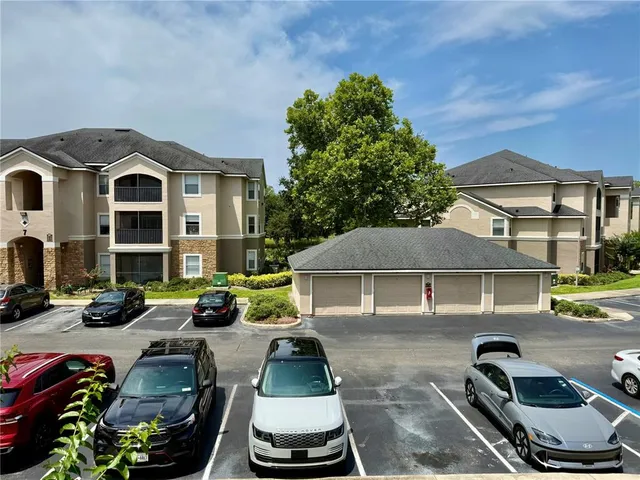 a view of a patio with table and chairs under an umbrella