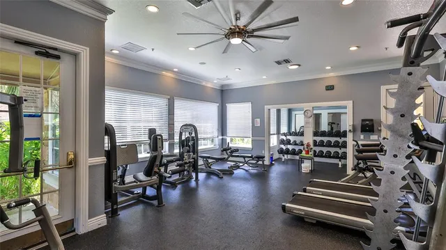 a gym room with lots of chairs and mirrors