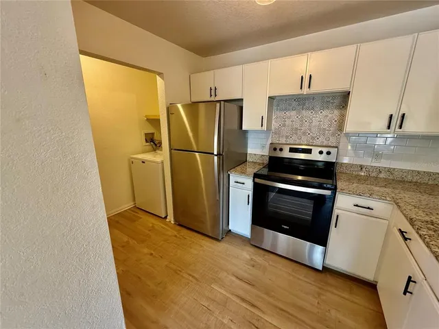 a kitchen with a refrigerator sink and stove